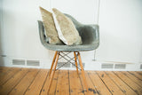Textured fabric and light tones of a vintage Turkish rug pillow.