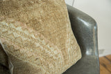 Subtle geometric pink and ivory Oushak pattern on vintage rug pillow.
