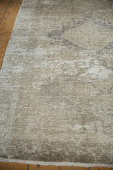 Distressed Oushak runner's textured pile in soft ivory and beige tones.