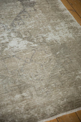 Distressed Oushak runner's textured pile in soft ivory, beige, and wooded tones.