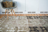 Dynamic distressed texture with bold geometric patterns in soft grey, sage, and black.