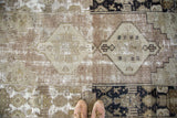 Textured distressed Oushak runner with geometric patterns and exposed foundation.