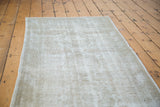 Vintage distressed Oushak rug texture in light silver, grey, and white.