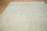 Distressed hand-knotted Oushak rug texture with airy light, apricot, and platinum tones.