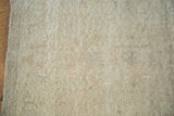 Faded distressed hand-knotted pile in airy light beige with subtle color variation.