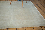 Vintage distressed Oushak rug showing faded light pile texture and platinum hues.