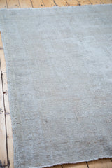 Distressed grey Oushak rug showcasing its embossed-like character and faded texture.