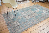 Distressed Oushak rug showing a teal blue-green field, scrolling arabesques, and Lehla Abassi border.