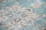 Distressed Oushak rug showing teal, ivory, charcoal scrolling arabesques and prawn border.