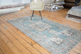 Distressed vintage Oushak rug with teal-green field, trefoil spandrel, and prawn border.
