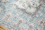 Distressed teal, apricot, and charcoal Lehla Abassi border on a vintage Oushak rug.