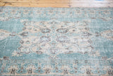 Distressed Oushak rug with teal blue-green quatrefoil medallion and prawn border.