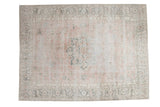 Distressed Oushak carpet with large Heriz-style medallion, scrolling vines, blush, grey, and ivory tones.