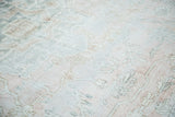Distressed Oushak carpet detail, showing faded blush, silvery grey geometric vines.