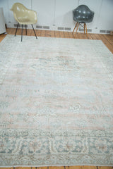 Distressed Oushak carpet border featuring blush, platinum, and silvery geometric patterns.