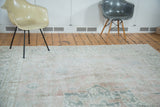 Distressed Oushak rug with muted blush and silvery grey Heriz style medallion and vines.