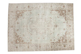Vintage distressed Oushak carpet, soft sea foam green field with faded brown medallion.