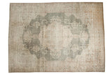Distressed Oushak carpet with faded forest green field and ivory floral medallion.