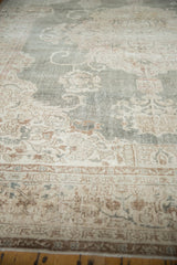 Faded distressed Oushak border, intricate floral designs in beige, bronze, and dusty blush.