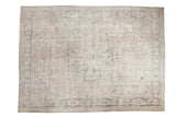 Hand-knotted distressed Oushak carpet featuring a large Heriz style medallion in ivory, silver, and grey.