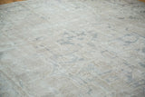 Distressed Oushak carpet's blanched ivory and soft grey tones with faded Heriz-style motifs.