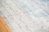 Distressed vintage Oushak carpet border, intricate floral design in ivory, beige, and apricot.