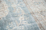 Faded slate blue distressed Oushak carpet pile with ivory and peach motifs.