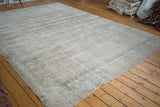 Distressed hand-knotted Oushak carpet with sun-faded rose blush field, mint celadon border.