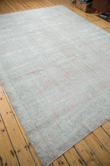 Distressed Turkish Oushak carpet in faded rose blush and mint celadon tones.