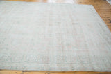 Distressed Turkish Oushak carpet in sun-faded rose blush and mint celadon palmette patterns.