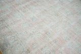 Distressed Oushak carpet showcasing faded rose blush field and soft celadon palmette patterns.