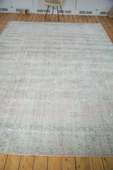 Distressed Oushak carpet with faded rose blush palmettes and mint celadon border detail.