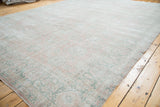 Distressed Oushak carpet texture, featuring soft sun-faded rose blush and mint celadon.