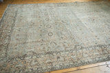 Distressed Oushak corner, showing faded silver platinum and peachy floral motifs.