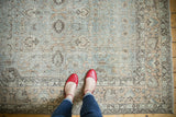 Distressed Oushak carpet with silver platinum field and faded peachy floral motifs near the border.