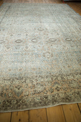 Distressed Oushak carpet border detail showing muted silver, platinum, and peachy floral motifs.