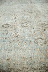 Faded silver platinum and peachy floral motifs on a distressed vintage Oushak carpet.