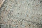 Distressed Oushak carpet corner with faded silver platinum and peachy floral motifs.