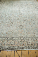 Distressed Oushak carpet, time-softened silver-platinum field, peachy floral motifs, and patterned border.