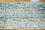 Distressed teal blue field texture, allover pattern, and faded beige border of vintage Oushak.
