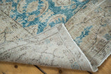 Distressed teal blue pile and hand-knotted beige foundation of a vintage Oushak carpet.