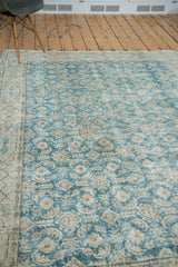 Distressed Oushak rug showing faded teal blue field and beige border pattern.