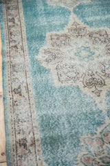 Distressed Oushak runner's soft aqua blue pile with classic ivory and blush border details.