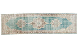 Distressed Oushak rug runner featuring ornate triple medallions in aqua blue, ivory, and blush.