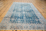 Distressed teal Oushak rug with curvilinear floral lattice pattern.