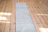 Distressed vintage Oushak runner with fading horizontal stripes in a neutral, earthy palette.