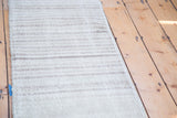 Distressed Oushak runner's textured horizontal stripes in neutral ivory and beige tones.