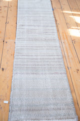 Distressed horizontal stripes in faded sea foam, ivory, and beige on an Oushak runner.