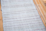 Textured distressed Oushak runner pile with subtle neutral horizontal stripes.