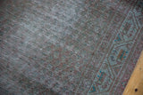 Vintage overdyed runner: distressed pile texture with subtle teal geometric border.
